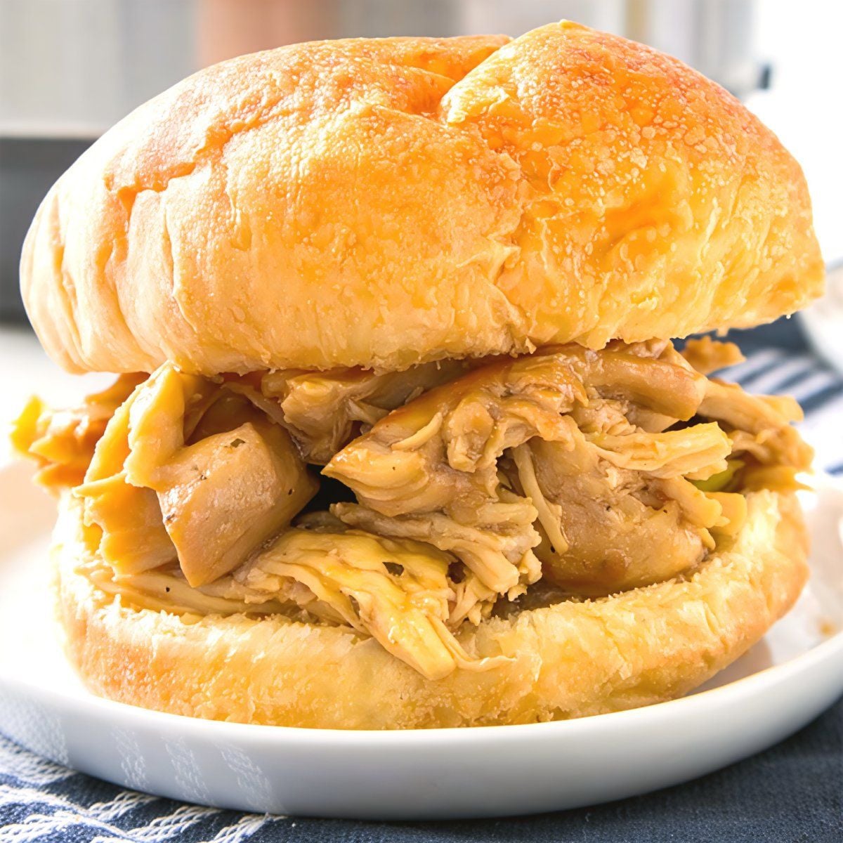 Tender shredded Mississippi Chicken served inside a golden low-carb bun, perfect for high protein low carb recipes dinner.