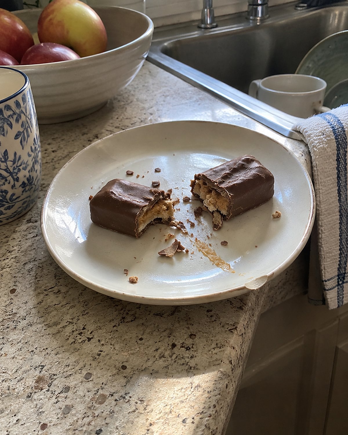 Flakes from a broken peanut-butter candy bar scattered beside the sink.