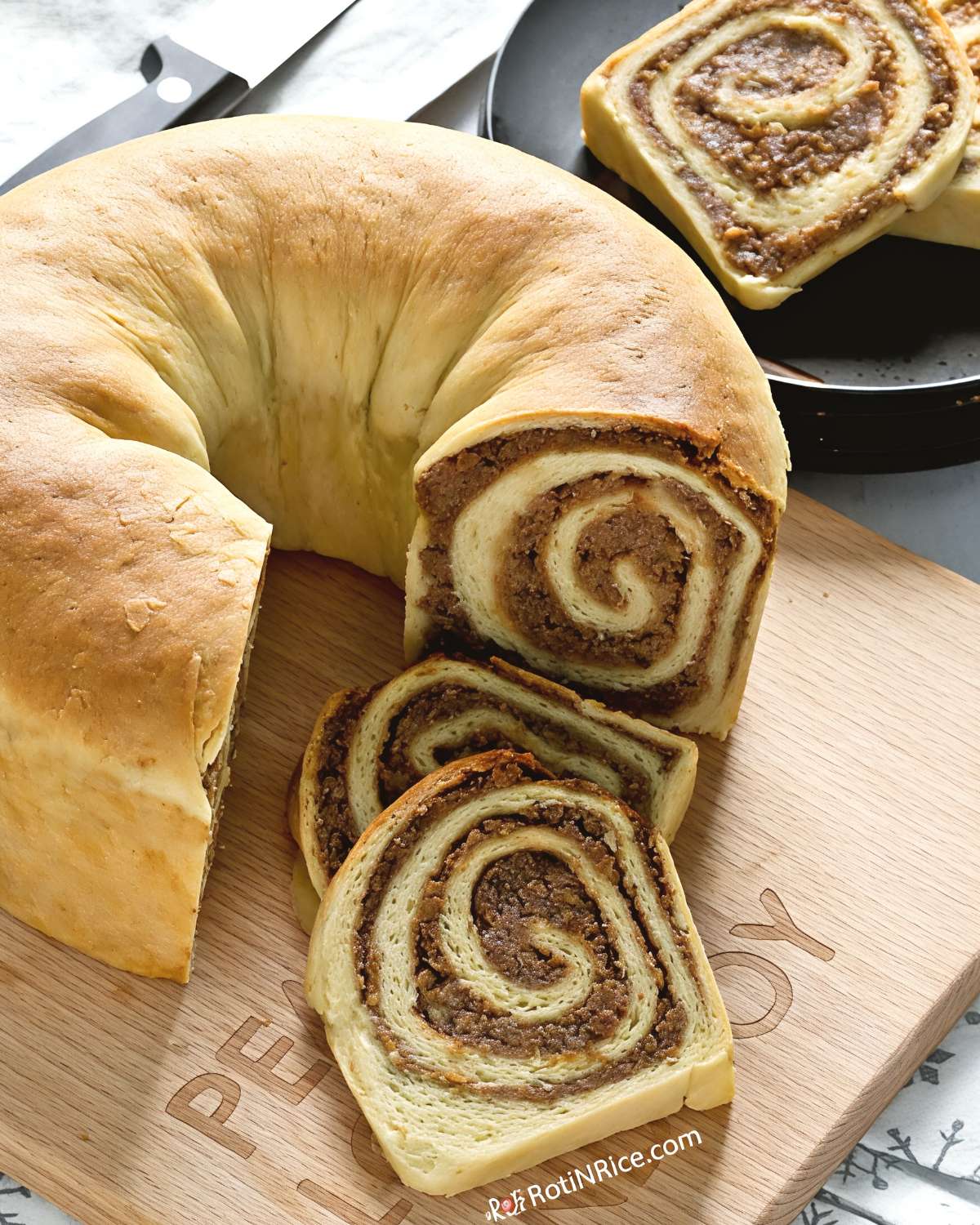 Slices of traditional Slovenian Potica nut roll cake showing intricate spiraled layers of walnut filling, served as a festive European Christmas dessert.