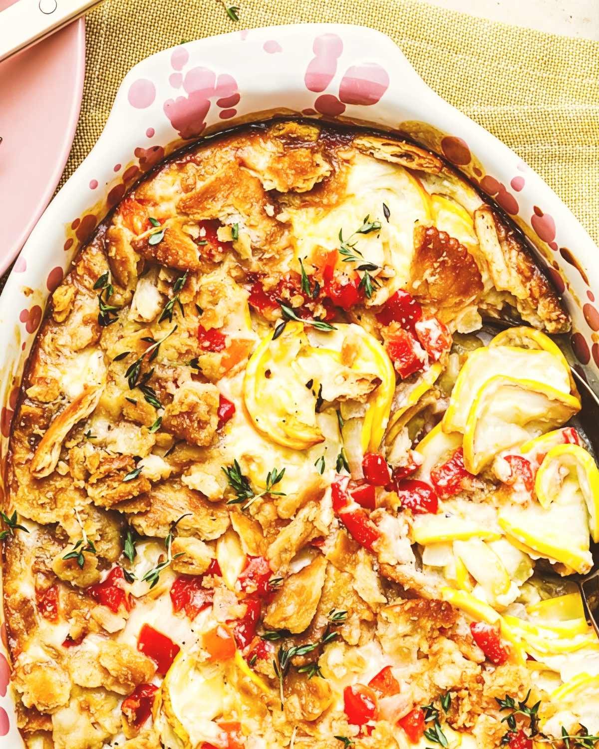 Southern squash casserole baked with yellow squash, red peppers, and a crunchy topping as a traditional Thanksgiving side dish