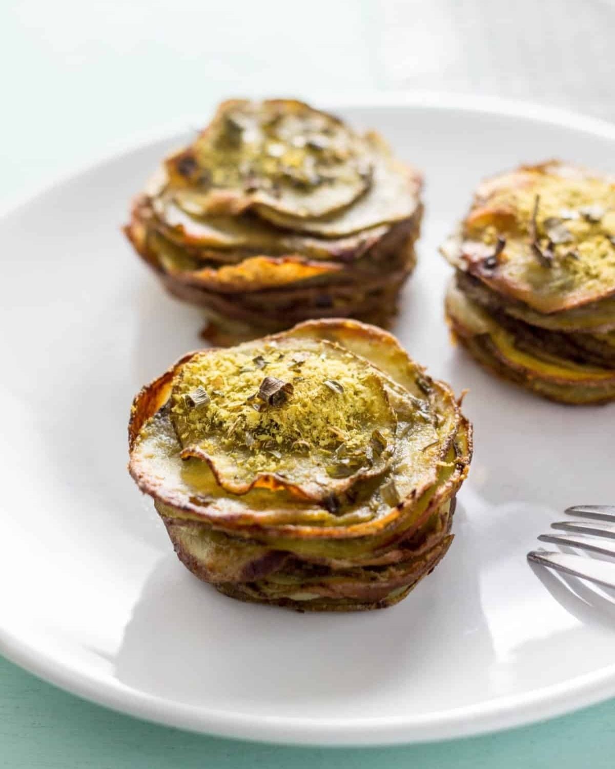 Crispy layers of vegan cheesy potato stacks seasoned with herbs and baked to perfection, ideal for vegan Thanksgiving appetizers.
